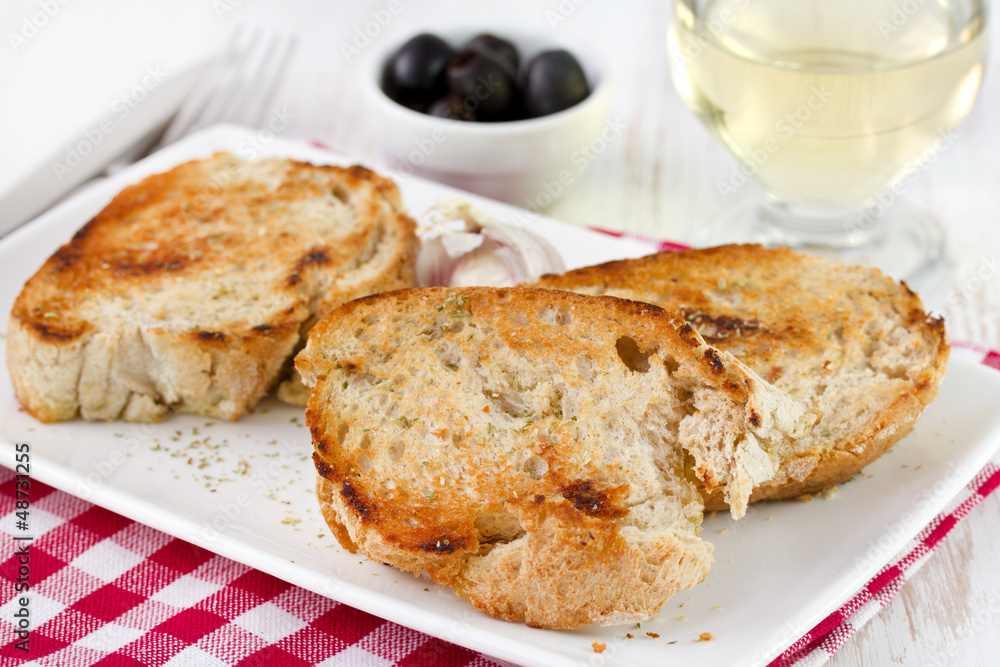 fried bread on the plate with olives and wine fried bread on the plate with olives and wine