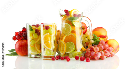 transparent jar and glasses with exotic fruits, isolated