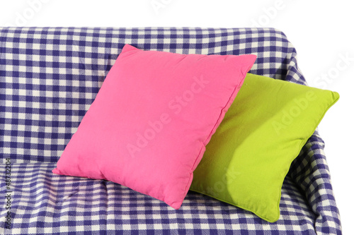 Colorful pillows on couch isolated on white © Africa Studio