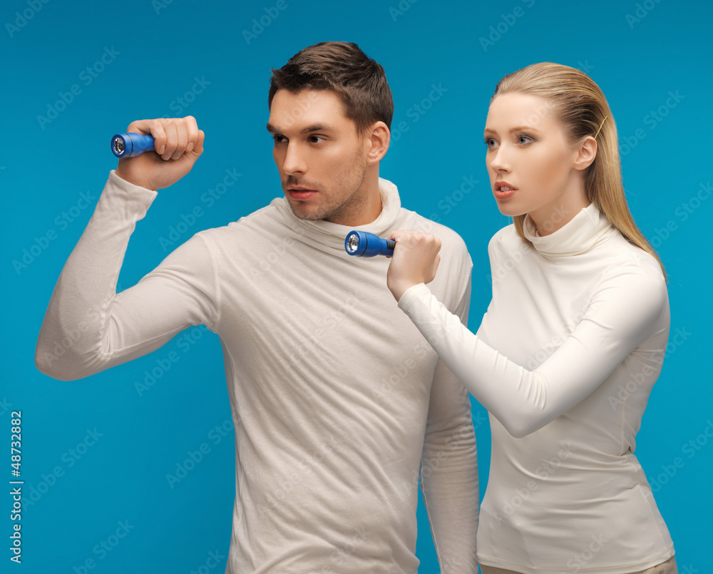man and woman with pocket flashlights man and woman with pocket flashlights