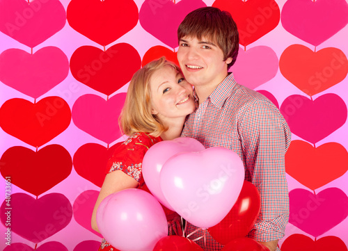 studio shot of young couple in love over colorful background