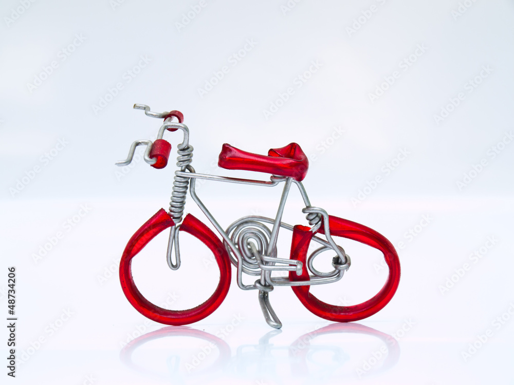 Fototapeta premium A miniature red bicycle isolated on white background in top view