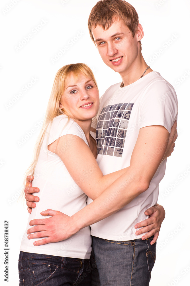 Happy smiling young couple standing together hugging Happy smiling young couple standing together hugging