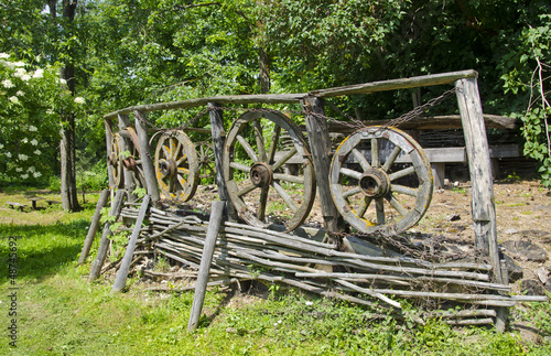 vintage wooden fence with carriage wheels