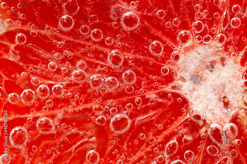 Fresh grapefruit in water with bubbles