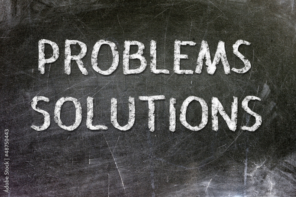 Fototapeta premium Problems Solutions handwritten with white chalk on a blackboard.