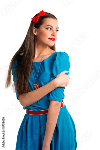 Cute young woman in blue dress on white background
