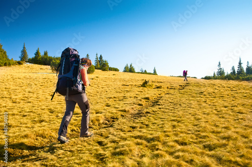 Hiker walking in autumn mountains