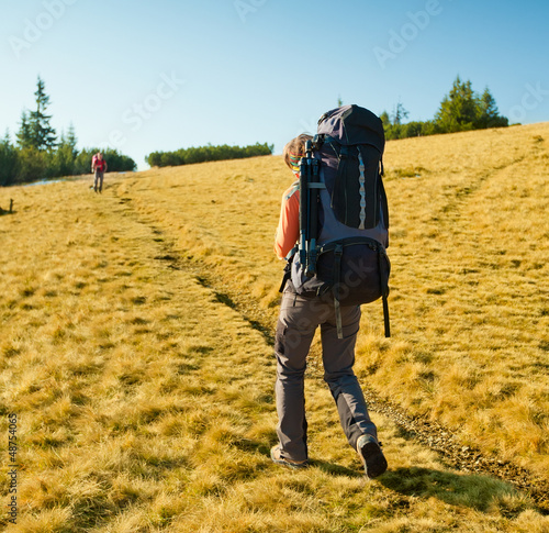 Hiker walking in autumn mountains