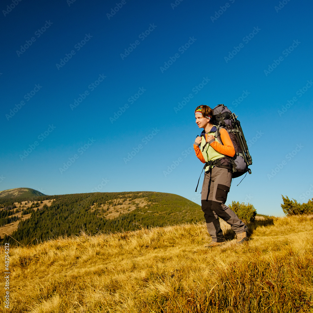 Hiker walking in autumn mountains Hiker walking in autumn mountains