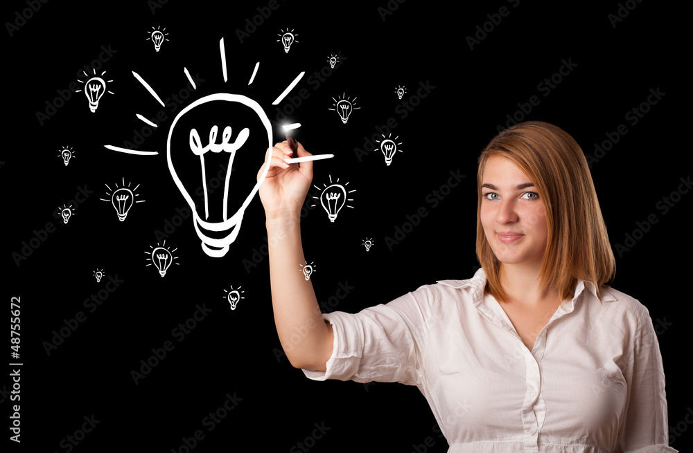 Woman drawing light bulb on whiteboard Woman drawing light bulb on whiteboard