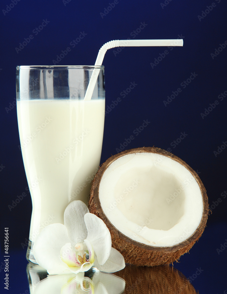 Coconut with glass of milk, on blue background Coconut with glass of milk, on blue background
