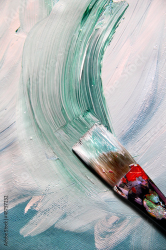 Mixing painting on the canvas and paintbrush