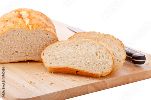 Bread on chopping board isolated on white