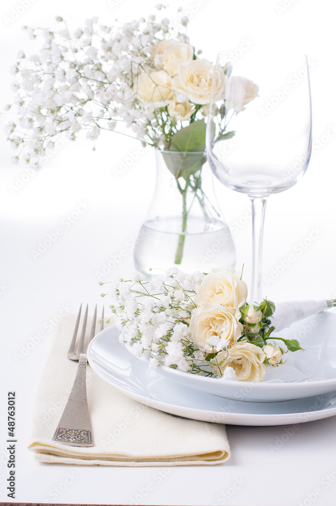 table setting with roses in bright colors and vintage crockery