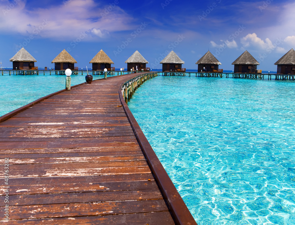 Island in ocean, overwater villas