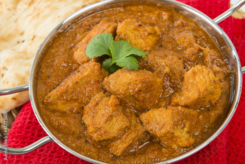 Goan Pork Vindaloo - Indian pork curry with naan bread photo