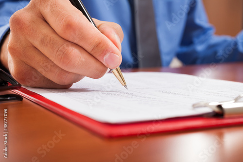 Man writing on a document