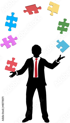 Business man juggling puzzle pieces problems