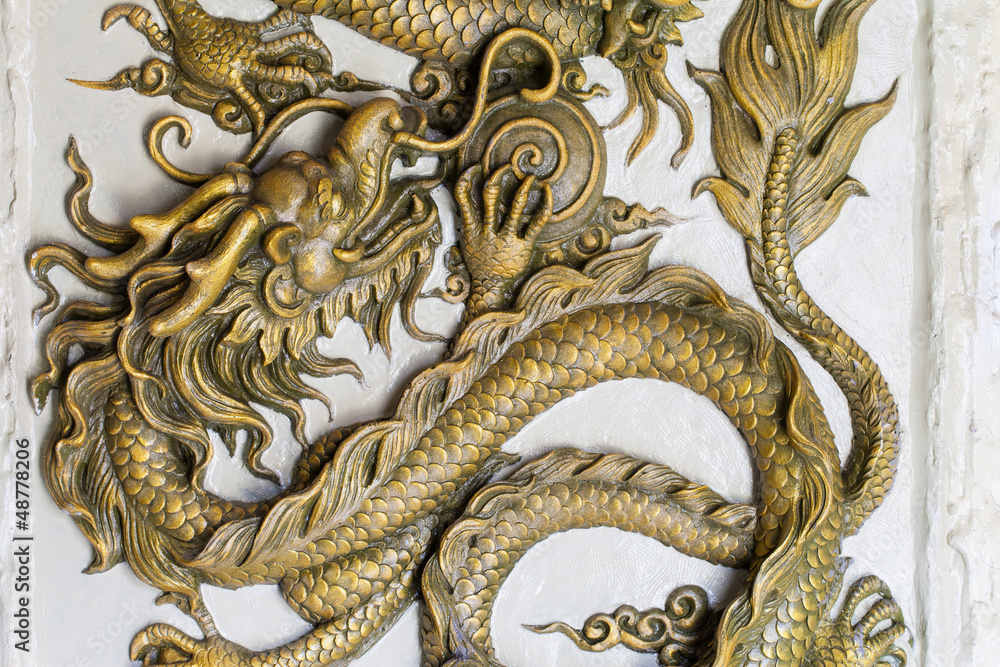 Fototapeta premium Dragon Sculpture on a wall