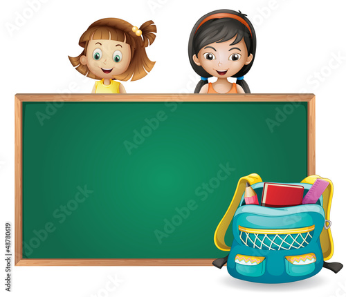 Smiling kids and a green board