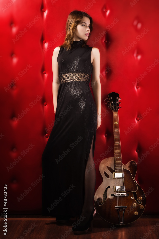 Elegant woman in black with guitar