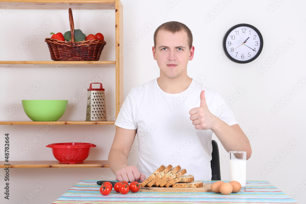 young man thumbs up in the kitchen young man thumbs up in the kitchen