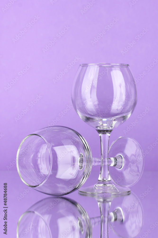 Two empty wine glasses on color background Two empty wine glasses on color background