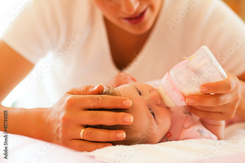 Mother is feeding the baby photo