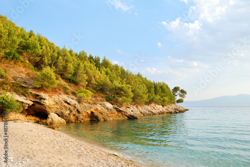 Sandy Beach and Green Hill with Blue Sea