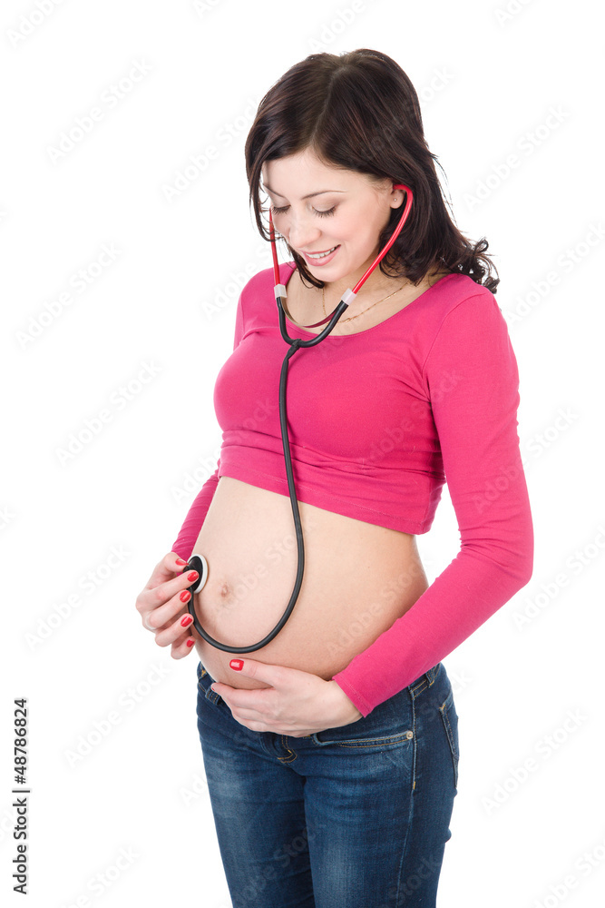 Pregnant woman examining belly with stethoscope . isolated Pregnant woman examining belly with stethoscope . isolated