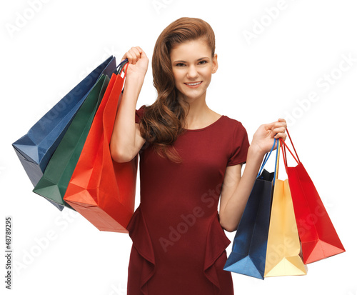 teenage girl in red dress with shopping bags