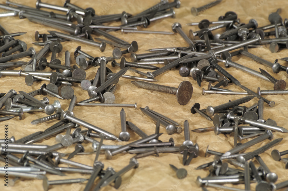 various size iron nails on the brown paper background - DSC0950 various size iron nails on the brown paper background - DSC0950