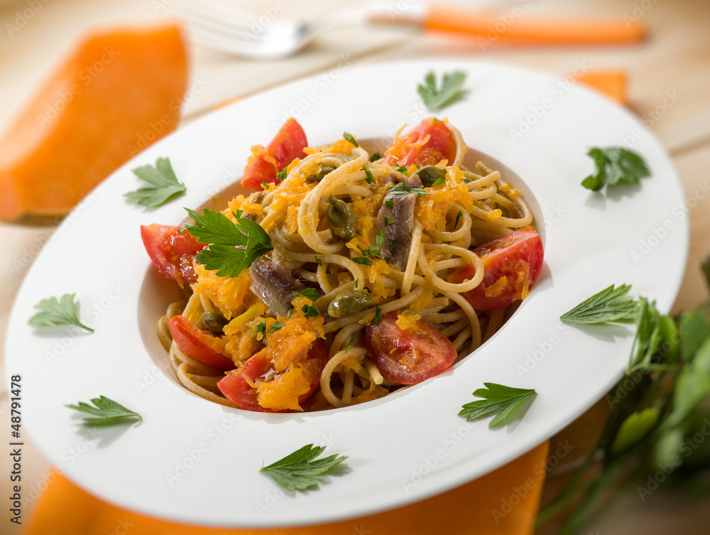 spaghetti with pumpkin anchovy caper  tomatoes, selective focus