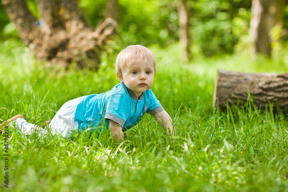 Happiness Baby boy sitting on the grass in field Happiness Baby boy sitting on the grass in field