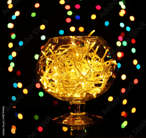 Christmas lights in glass bowl on blur lights background