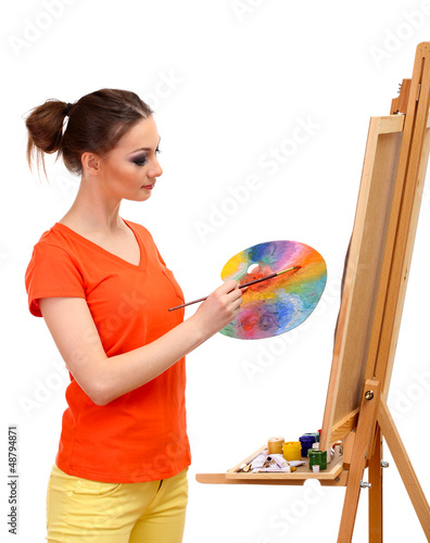 beautiful young woman painter at work, isolated on white photo