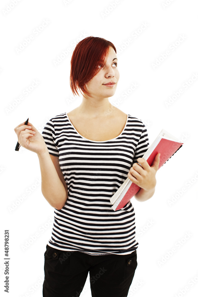 A woman taking notes with a smirk on her face, looking up A woman taking notes with a smirk on her face, looking up