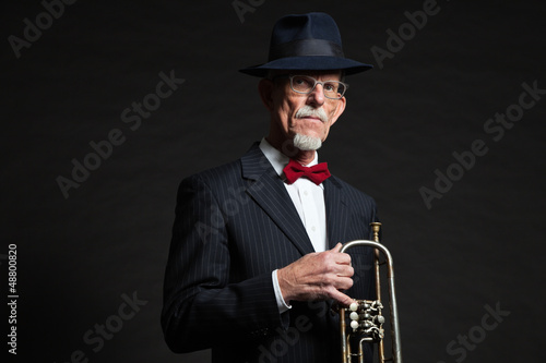 Senior jazz musician. Trumpet player. Studio shot.