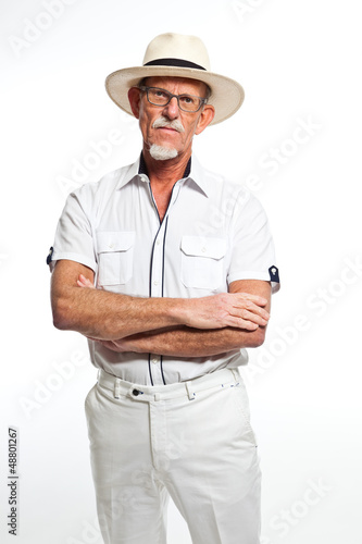 Well summer dressed senior man with hat. Isolated.