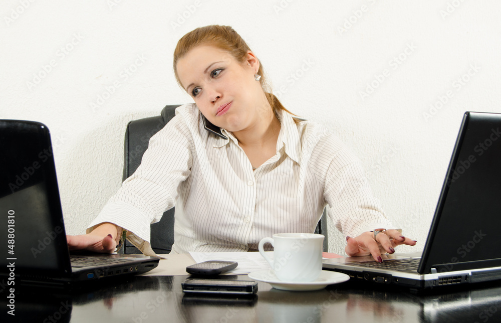 Stressed business woman multitasking in her office Stressed business woman multitasking in her office