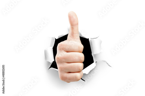 Obraz na plátně A view of a thumb up through a hole in paper