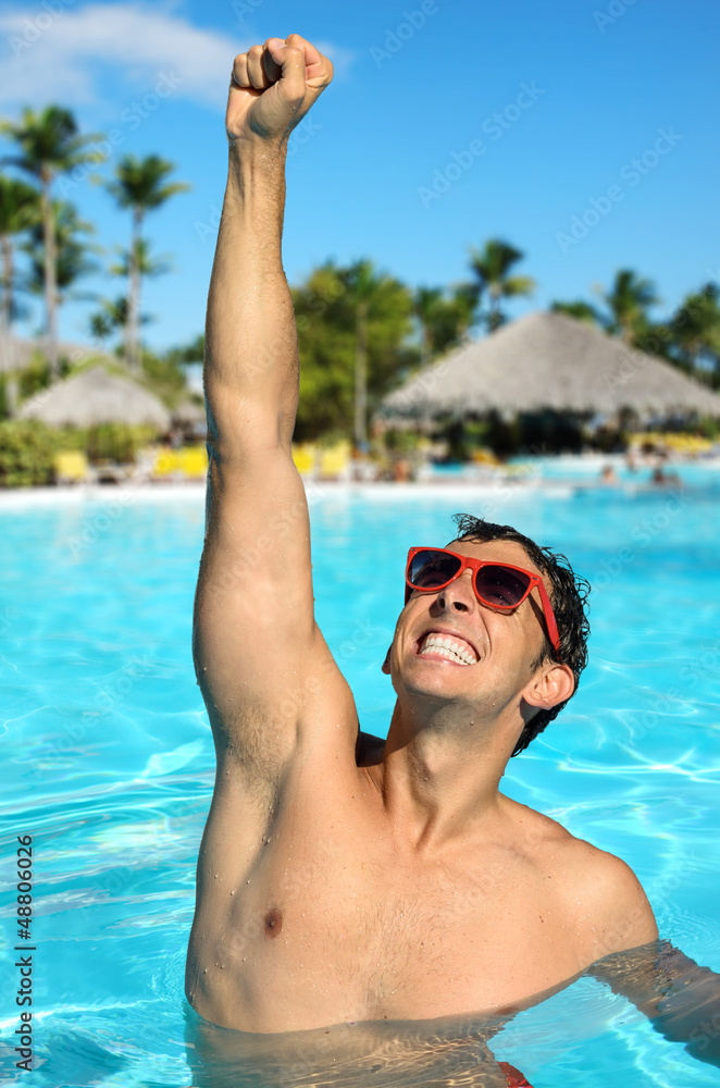 Man in tropical resort pool