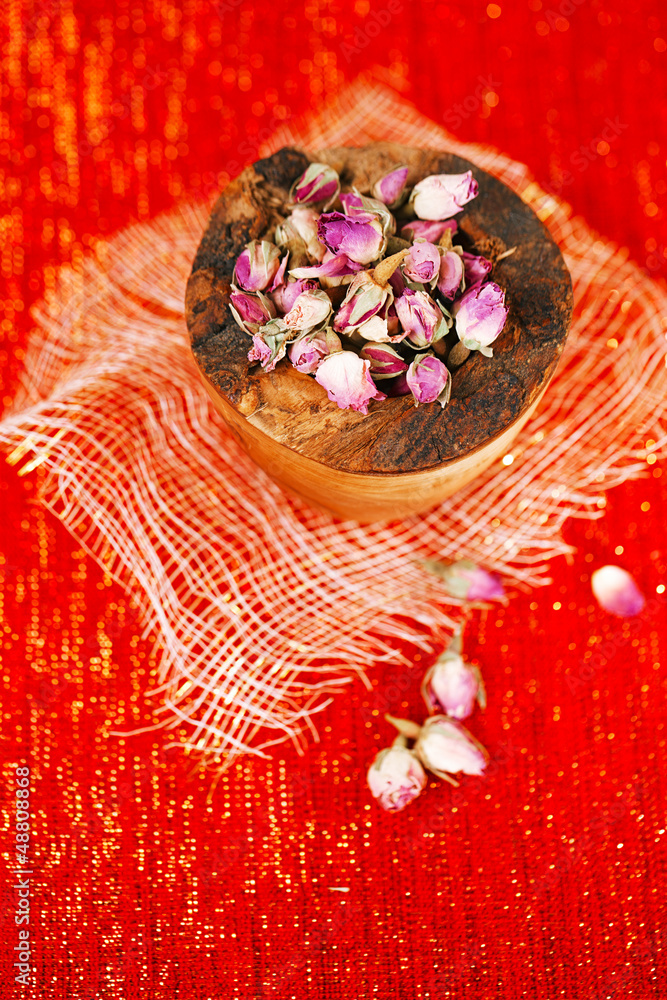 rose tea buds in wooden bowl