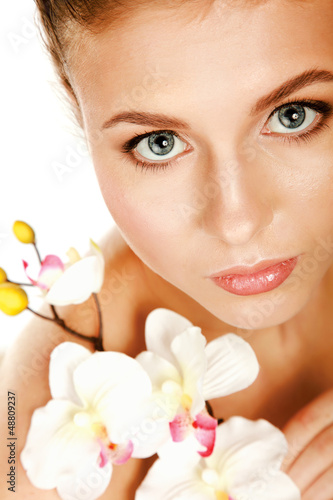 A young woman with orchid  isolated on white