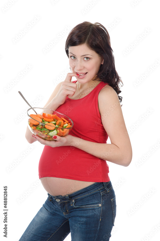 pregnant girl eats salad. isolated on white pregnant girl eats salad. isolated on white