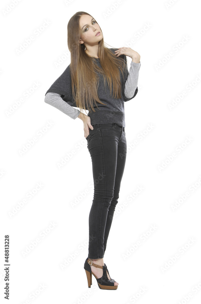 Full length of female in jeans looking sideways isolated Full length of female in jeans looking sideways isolated