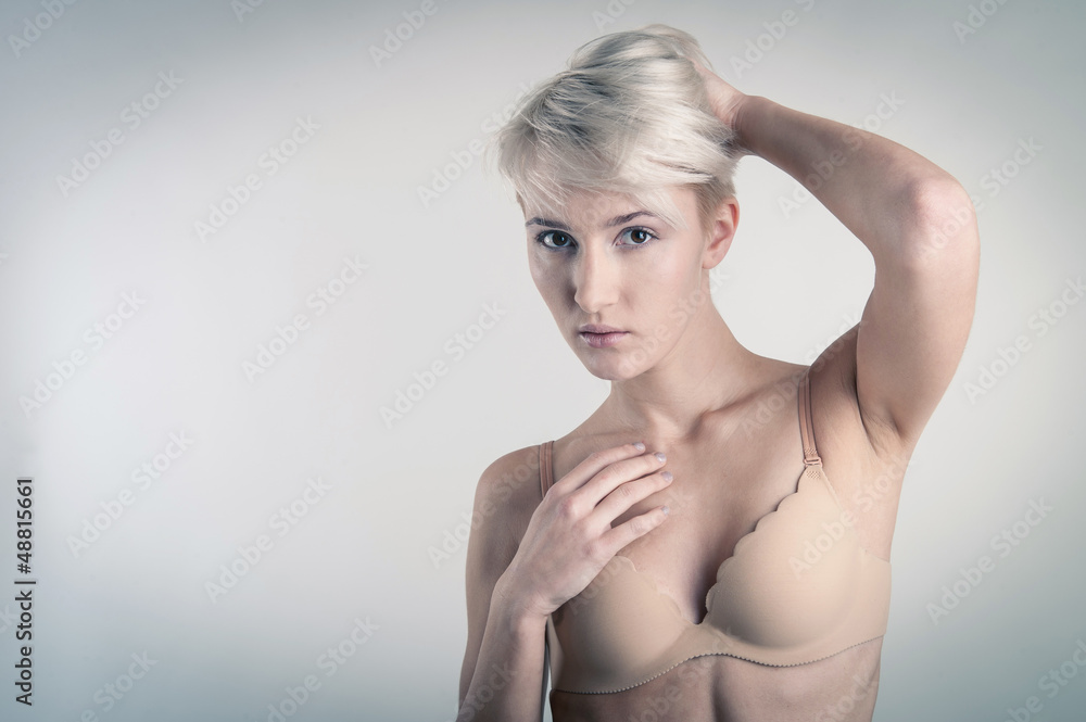 Sensual woman portrait in lingerie on light background. Sensual woman portrait in lingerie on light background.