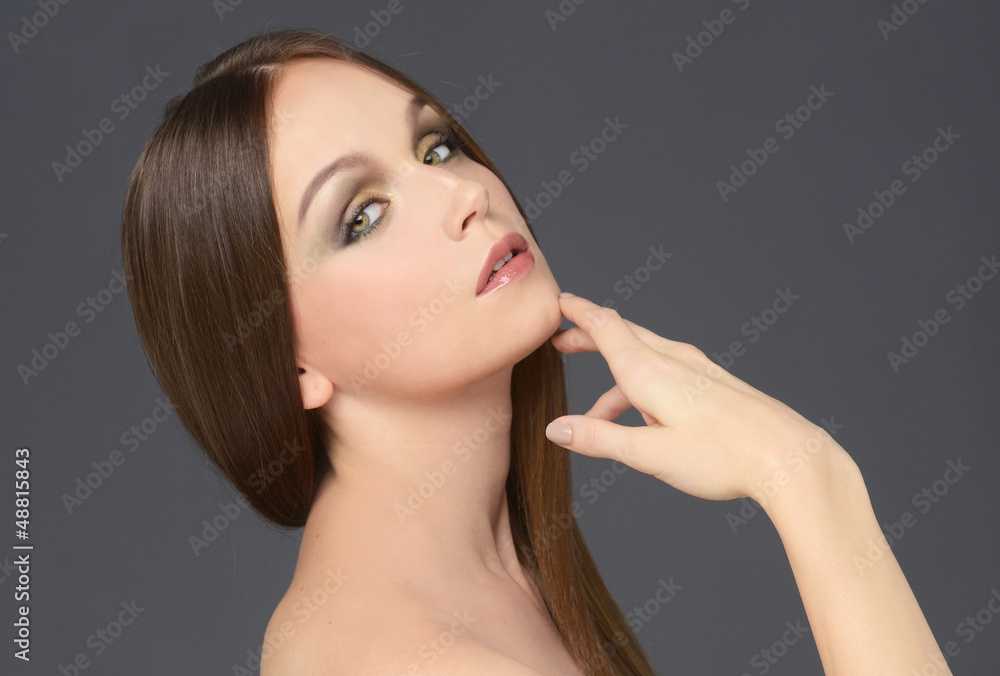 Fototapeta premium beautiful girl with long wonderful hair on gray background