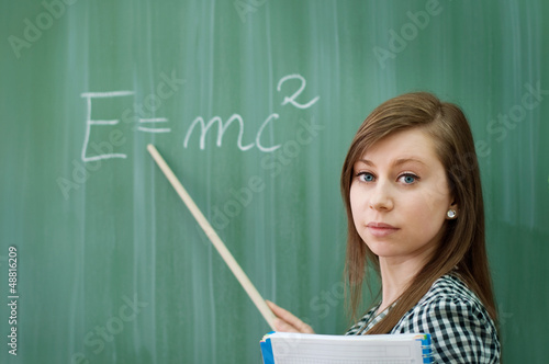 Naklejka Student girl showing e=mc2 formula